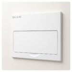Flush-mounted white Live Electrical consumer unit with closed lid, photographed against a light background.